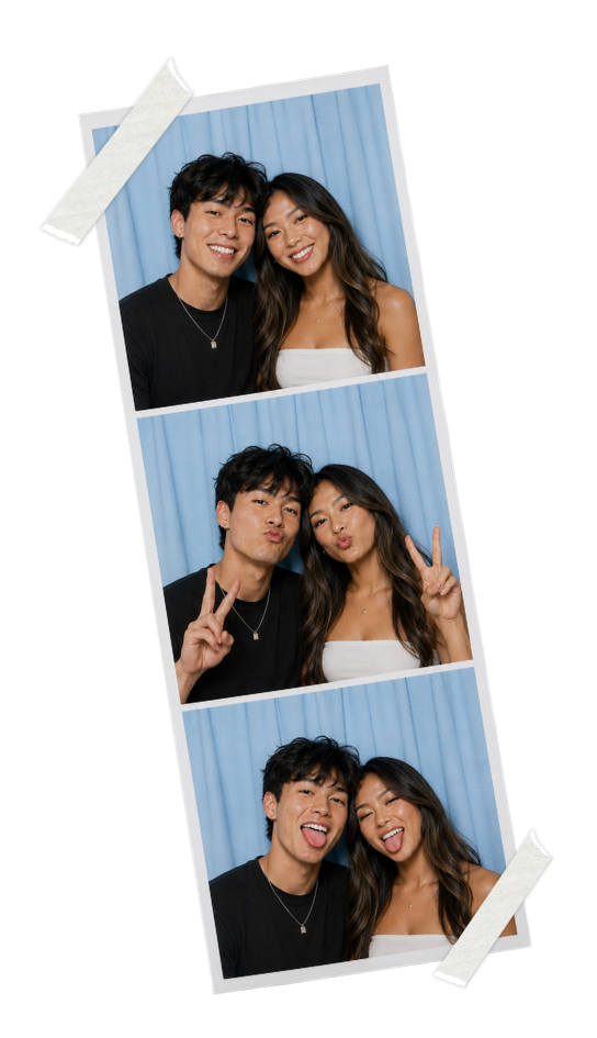 Couple smiling in a SmileMore booth with a blue curtain, strip taped up